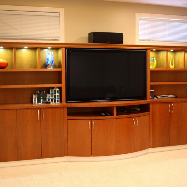 Cherry entertainment unit with curved center section and multiple display niches.